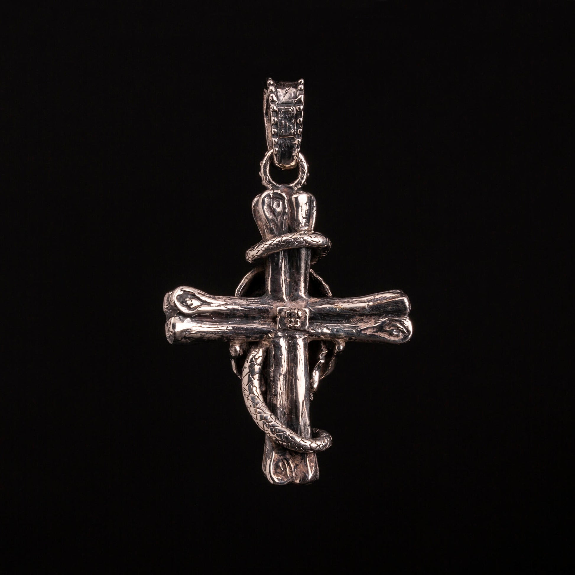 pendente in argento925 con ossa incrociate sormontate da teschio con granato e avvolto da serpente.